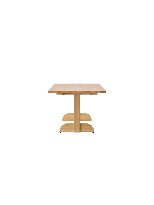 Puffin Dining Table, Rectangular in solid natural oak, showing the side profile and rounded base on a white background.