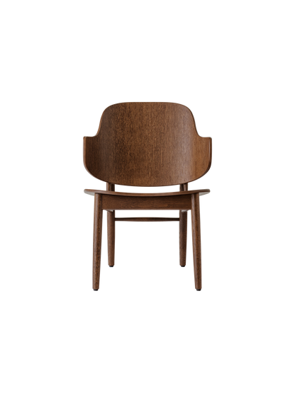 The Penguin Wooden Lounge Chair in red-stained oak, featuring a curved veneer back and solid oak frame.