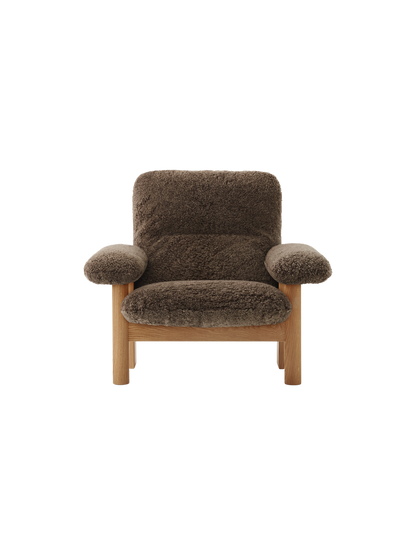 Front view of the high-back Brasilia Lounge Chair with a natural oak frame and upholstered in dark brown Root sheepskin.
