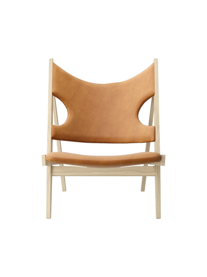 Front view of the Knitting Lounge Chair in Natural Oak, upholstered in Dunes Cognac leather with distinctive elbow cut-outs.