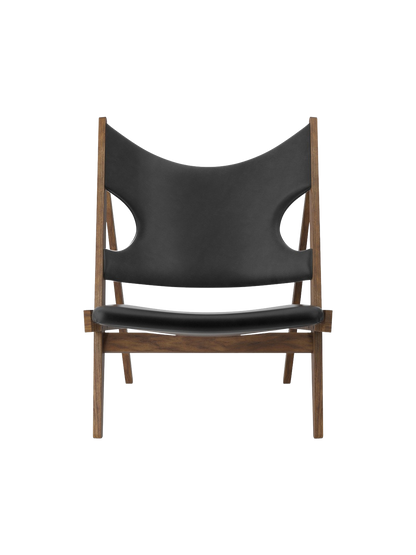 Knitting Lounge Chair shown from the front, with a walnut frame and black leather featuring signature cut-outs.