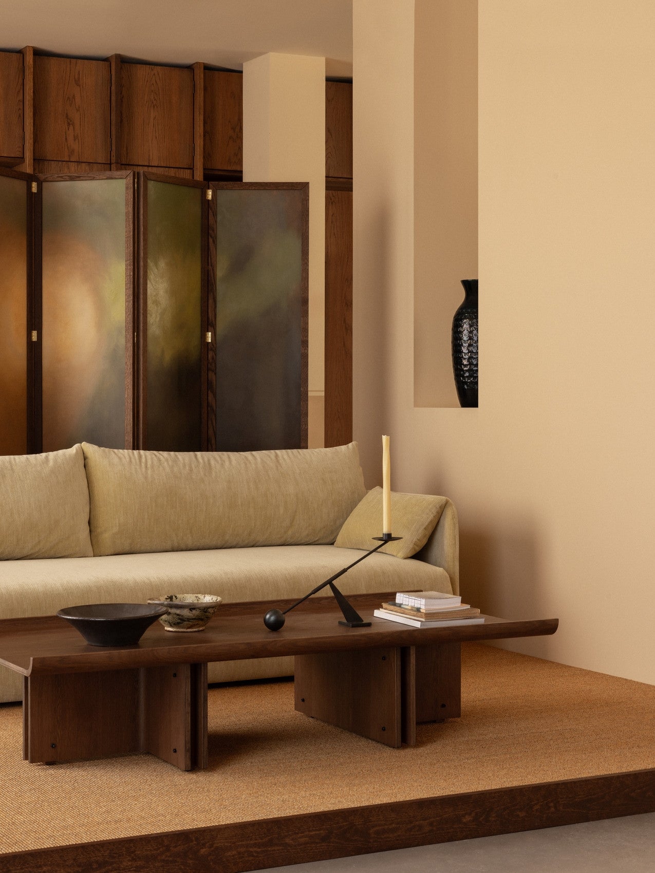 Conrad Lounge Table in dark stained oak veneer paired with a sofa and decorative items in a styled interior setting.