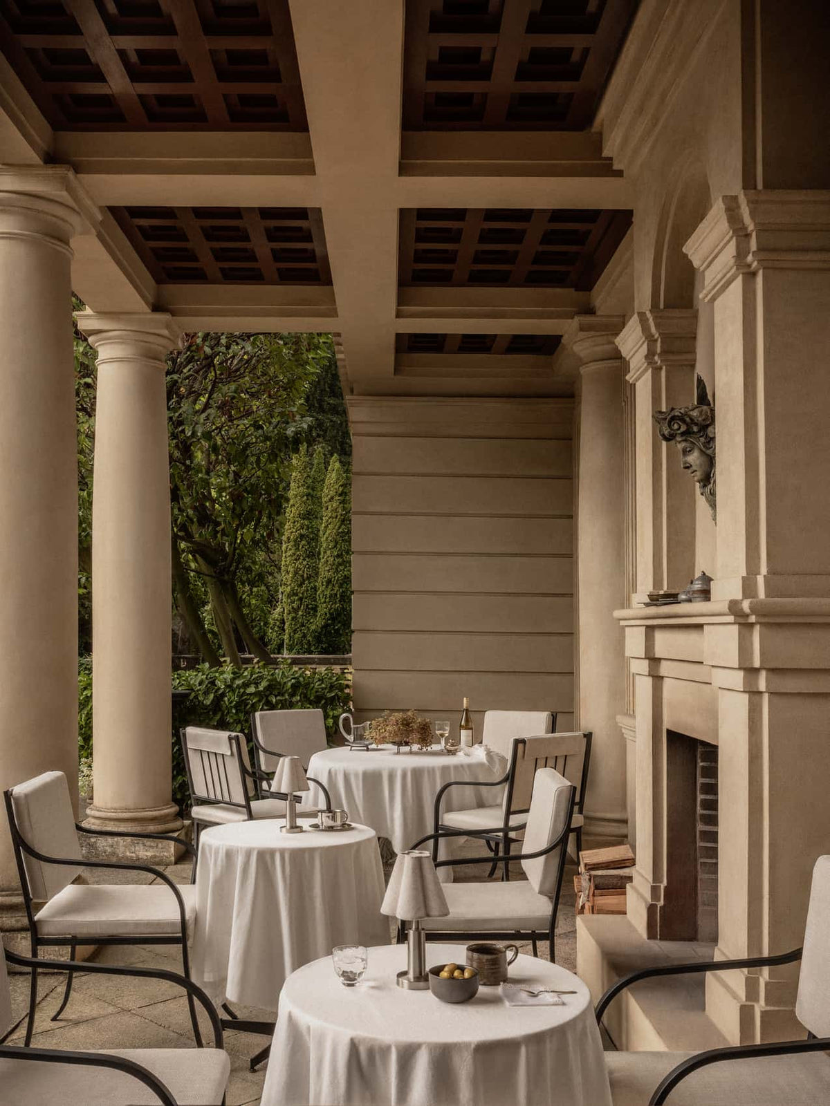 Bloss Garden Dining Chair paired with outdoor tables and Admiral Portable Lamps on a covered terrace.