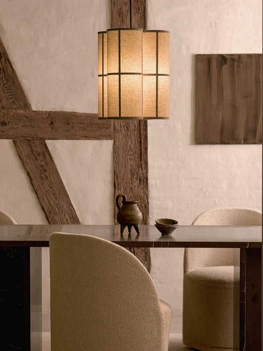 Hashira Pendant Lamp Cluster hanging above a dark dining table with upholstered chairs in a rustic interior.