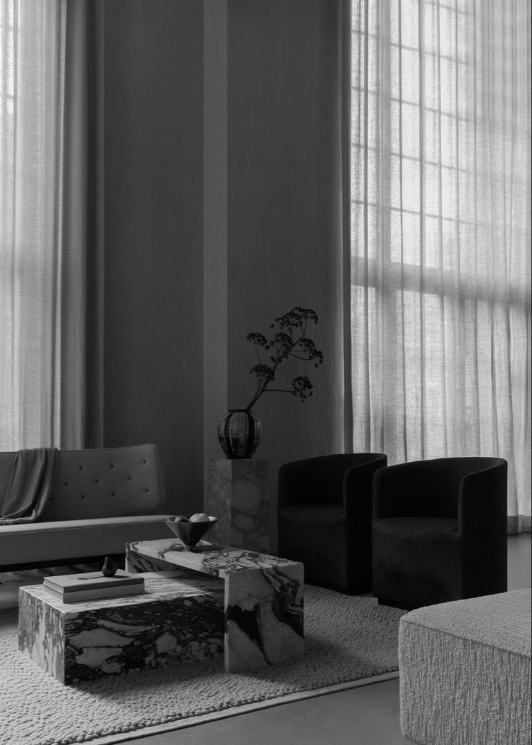 Plinth Low table and Radiohus Sofa paired with Tearoom Club Chairs, a Gravel Rug, Taper Bowl, and Sentiment Paper Weight.