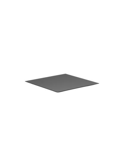 A thin, square, black metal base for the Kubus 4 candleholder, displayed at an angle against a stark black background.
