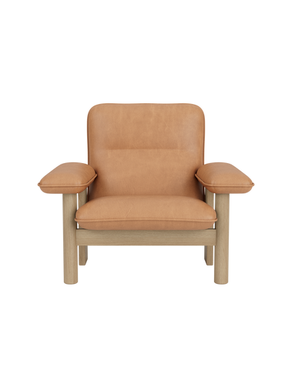 Brasilia Lounge Chair in natural oak and camel leather. A minimalist modern armchair with a sturdy frame and plush cushions.