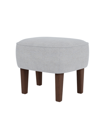 The Ingeborg Ottoman in a light grey Fiord 751 textile, shown from a three-quarter angle with dark-stained smoked oak legs.