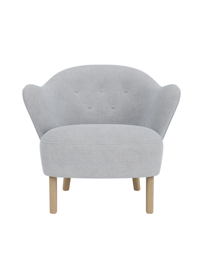Front view of the Ingeborg Lounge Chair, featuring a light grey Fiord 751 textile upholstery and four natural oak legs.