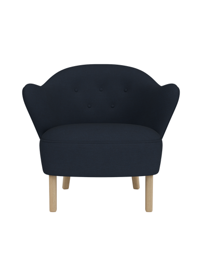 Front view of the Ingeborg Lounge Chair in dark navy Fiord 782, with a button-tufted backrest and natural oak legs.