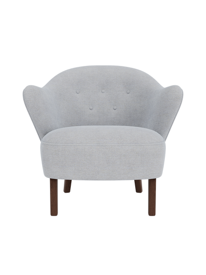 Front view of the Ingeborg Lounge Chair in a light grey fabric with four tufted buttons and dark stained oak legs.