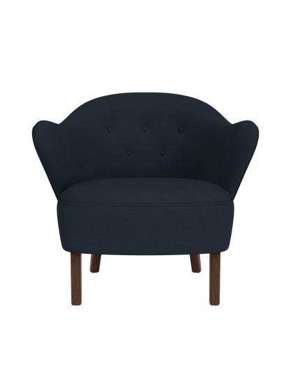 Front view of the Ingeborg Lounge Chair in dark blue Fiord 782 textile, featuring a tufted back and dark smoked oak legs.