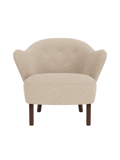 Front view of the Ingeborg Lounge Chair in textured beige fabric, with a button-tufted back and smoked oak legs.