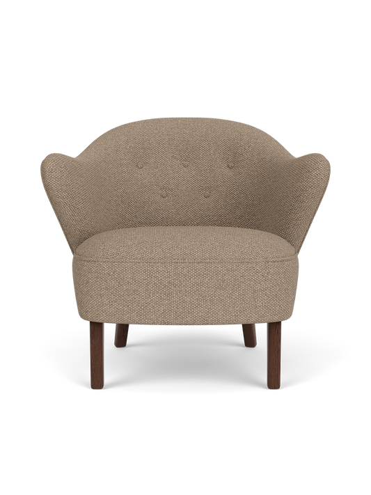 Ingeborg Lounge Chair in Logan Flint textile with dark stained oak legs, featuring a sculptural, curved silhouette.