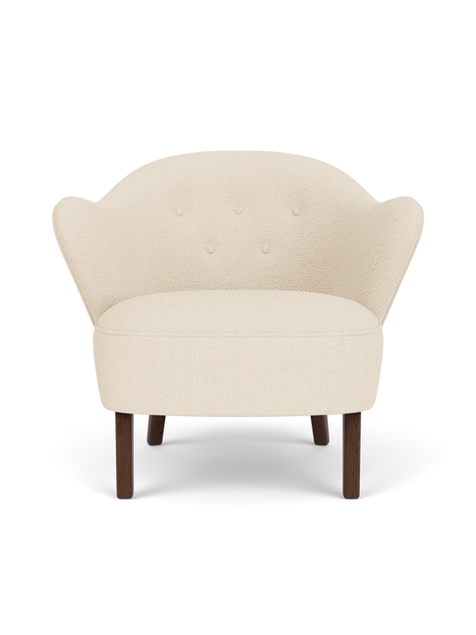 Ingeborg Lounge Chair in Logan Jasmine textile featuring sculptural armrests and dark stained oak legs.