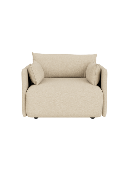 A front, high-angle view of the Offset Sofa, a one-seater armchair upholstered in textured, sand-coloured Logan fabric.