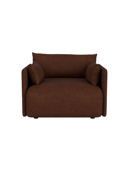 A front view of the Offset Sofa, a one-seater armchair in textured brown Audo Bouclé 08 fabric on a black background.