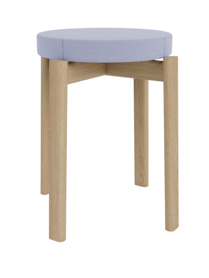 A front-facing view of the Passage Stool, Upholstered, with a natural oak frame and a round, padded seat in pale blue fabric.