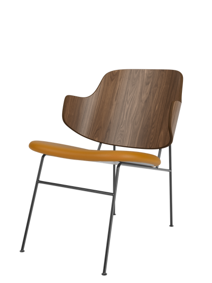 The Penguin Lounge Chair, featuring a curved walnut veneer backrest and a tan upholstered seat on a thin black metal frame.