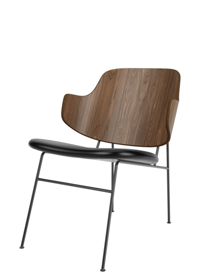 The Penguin Lounge Chair with a curved walnut veneer backrest and a black leather seat on a black powder-coated steel frame.