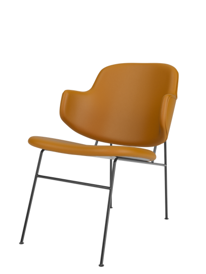 A side-angle view of The Penguin Lounge Chair, fully upholstered in tan leather with a dark powder-coated steel frame.