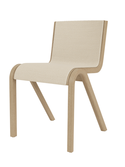 A three-quarter view of the Ready Dining Chair, Front Upholstered, with a natural oak frame and light, textured upholstery.