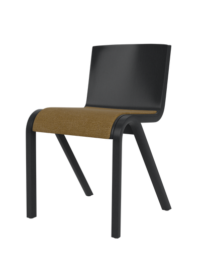 A side-angle view of the Ready Dining Chair, featuring a black painted oak frame and a golden-brown bouclé upholstered seat.