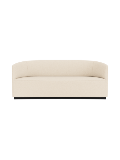 Front view of the Tearoom Sofa in a light-coloured Logan Jasmine fabric, featuring a curved back and arms on a dark base.
