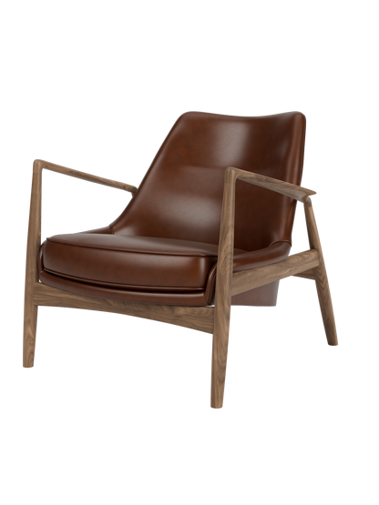 A three-quarter view of The Seal Lounge Chair, Low Back, featuring a dark walnut frame and smooth, brown leather seating.