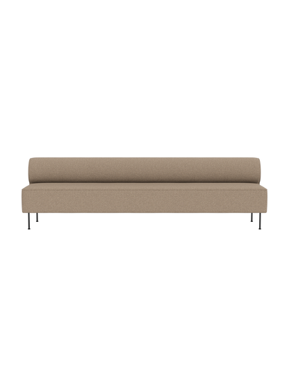Front view of Eave Dining Sofa in Logan Flint. A long, minimalist beige sofa with slender black legs on a black background.