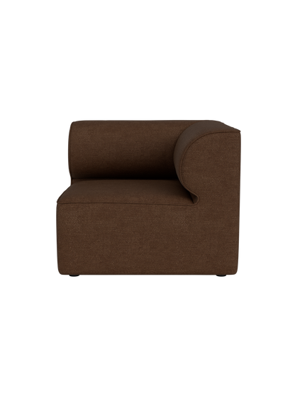A side profile of the Eave Modular Sofa, 86, Corner piece in a brown Audo Bouclé 07 fabric against a black background.