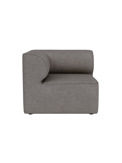 A front view of the Eave Modular Sofa 86 Corner in Audo Bouclé 16 fabric, showing its curved armrest on a black background.