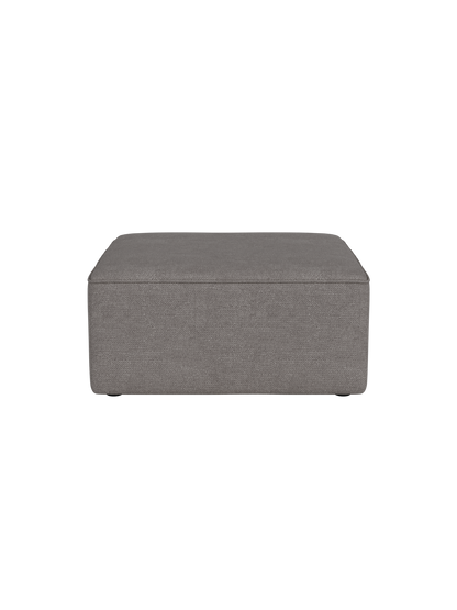 Eave Modular Sofa, 86, Pouf upholstered in a dark grey textured Audo Bouclé 16 fabric against a black background.