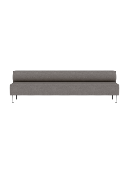 The Eave Dining Sofa in grey Audo Bouclé 16 fabric, featuring a long, low profile with a bolster back on slim legs.