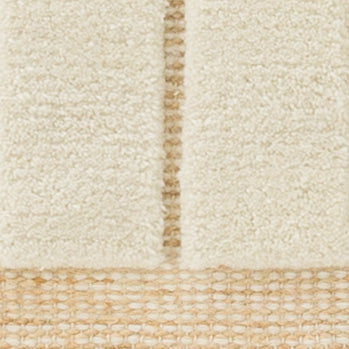 Detailed texture of the Tile Rug in Ivory, featuring plush off-white wool pile and natural woven jute.