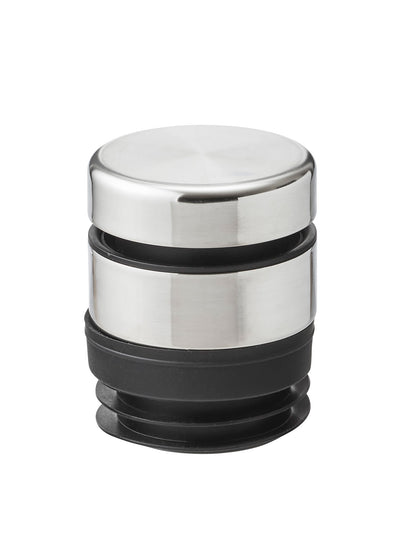 A close-up of the Audo To Go Tumbler Lid, showing its brushed stainless steel top and black silicone stopper base.