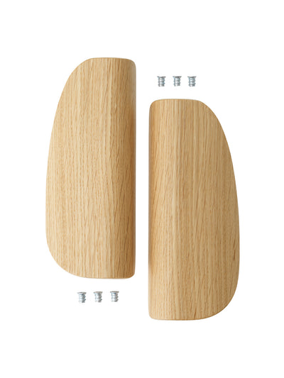 Pair of light oak wooden armrest/leg caps with rounded, tapered shapes and three small metal insert screws shown on white