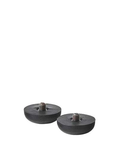 A pair of black, dome-shaped furniture glides with threaded metal screws protruding from the centre, on a white background.
