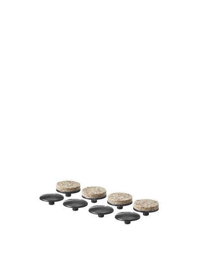 A set of four black plastic glides and four circular felt pads, components for the Felt Glides for Harbour Chair.