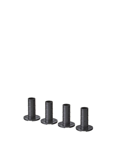 Four black cylindrical plastic furniture leg adapters with flanged bases, shown in a row on white background