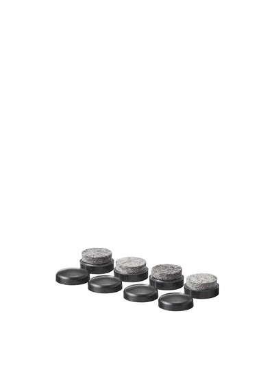 Studio shot of Harbour/Afteroom wood base glides, showing four black plastic pieces and four with grey felt pads.