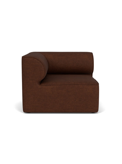 A front-on studio shot of the Eave Modular Sofa 96 Corner Left unit, upholstered in a textured, dark brown Bouclé 08 fabric.