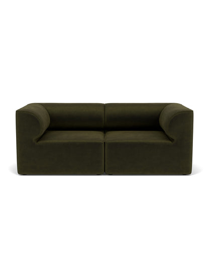Eave Modular Sofa, 96, 2-seater, in dark green fabric, showcasing its blocky form and curved internal armrests.